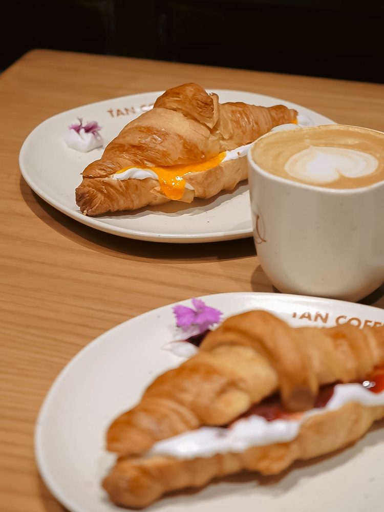 Butter croissants with a latte on a wooden table
