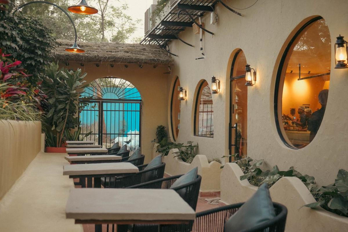 Round arched windows and lanterns along an outdoor terrace